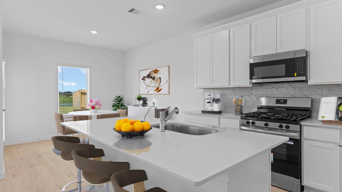 6324 Cherry Mdws Street Rosenberg, TX 77469 - Photo 9 of 41 a kitchen with stainless steel appliances granite countertop a sink a stove and cabinets