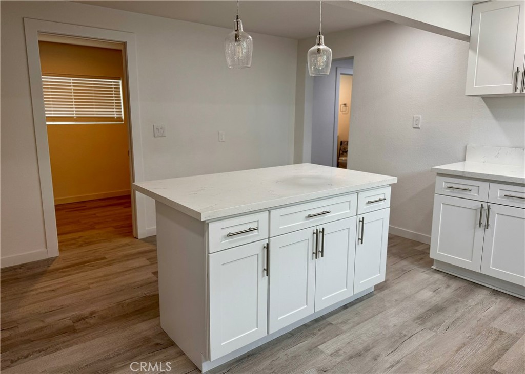1362 South Downey Road Los Angeles, CA 90023 - Photo 15 of 30 a kitchen with white cabinets and wooden floor
