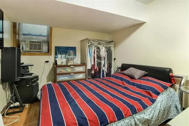 a bedroom with a bed and dresser