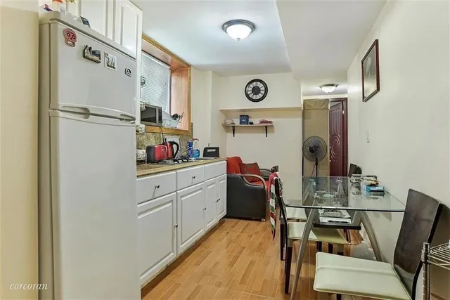 a kitchen with stainless steel appliances a refrigerator and a stove top oven