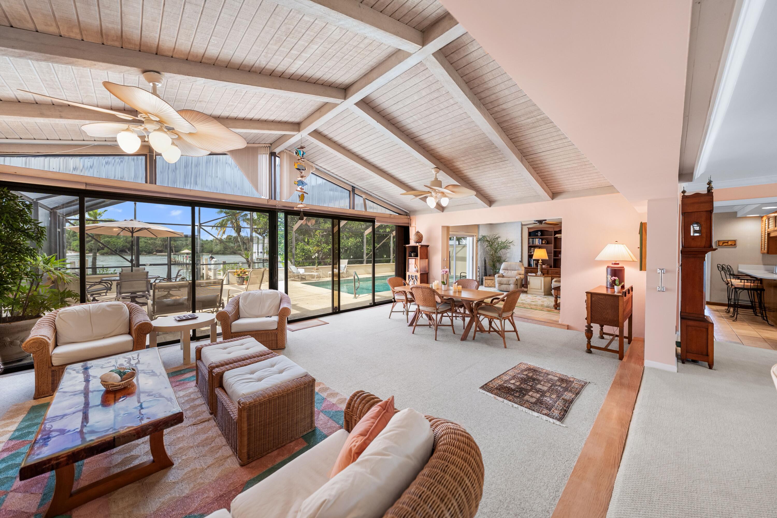 107 Lighthouse Drive Jupiter Inlet Colony, FL 33469 - Photo 2 of 11 a living room with furniture and a large window