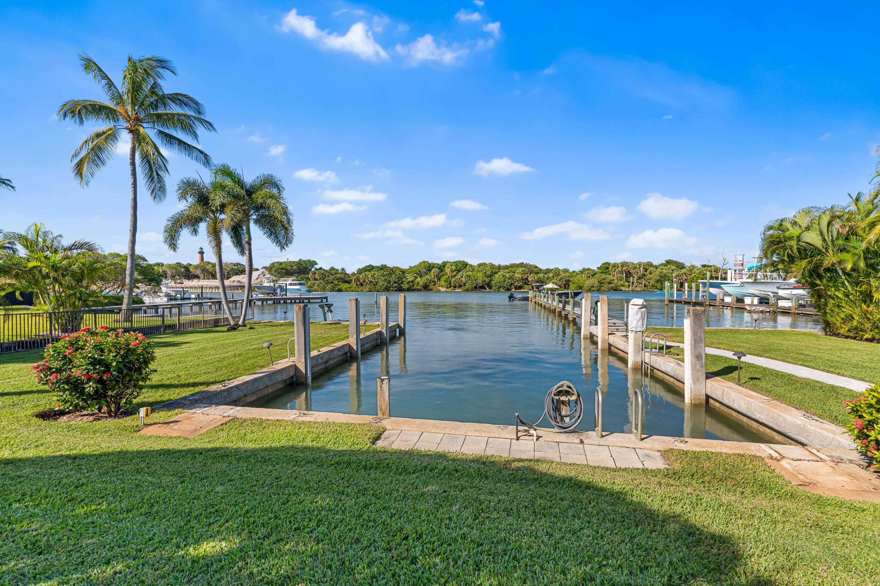 107 Lighthouse Drive Jupiter Inlet Colony, FL 33469 - Photo 6 of 11 a view of a lake with a building in the background