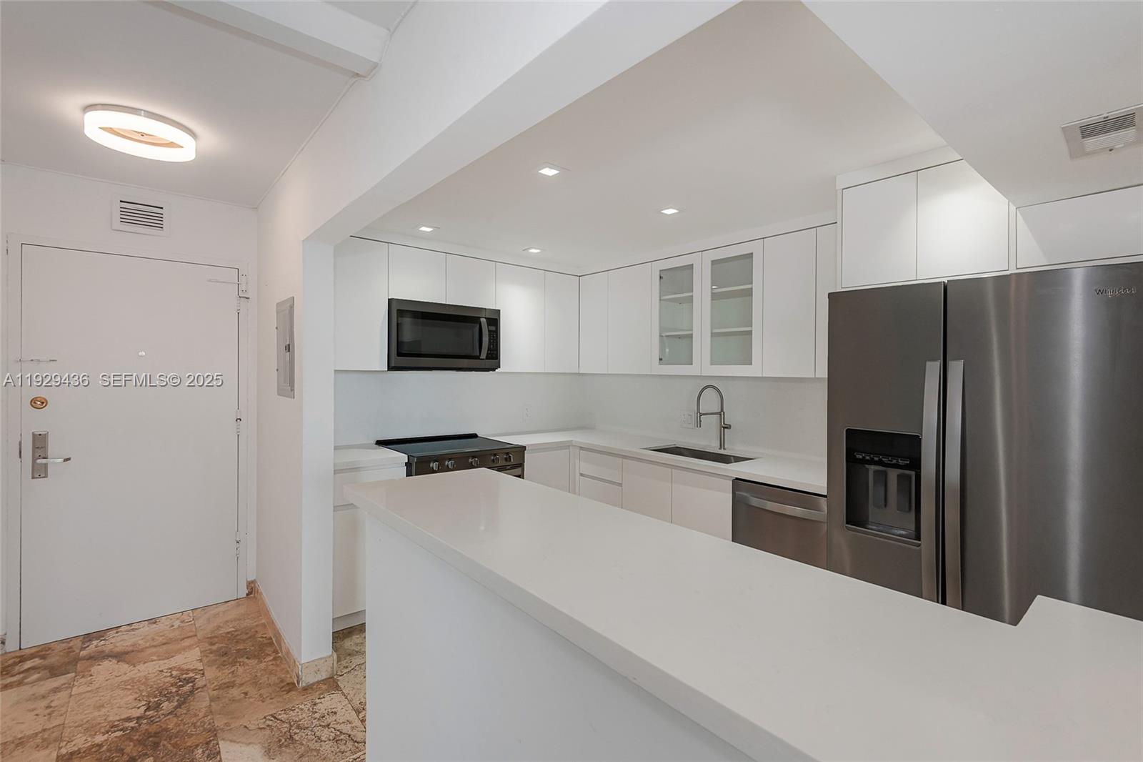 150 Southeast 25th Road, Unit 7J Miami, FL 33129 - Photo 12 of 29 a kitchen with stainless steel appliances a refrigerator stove microwave and sink