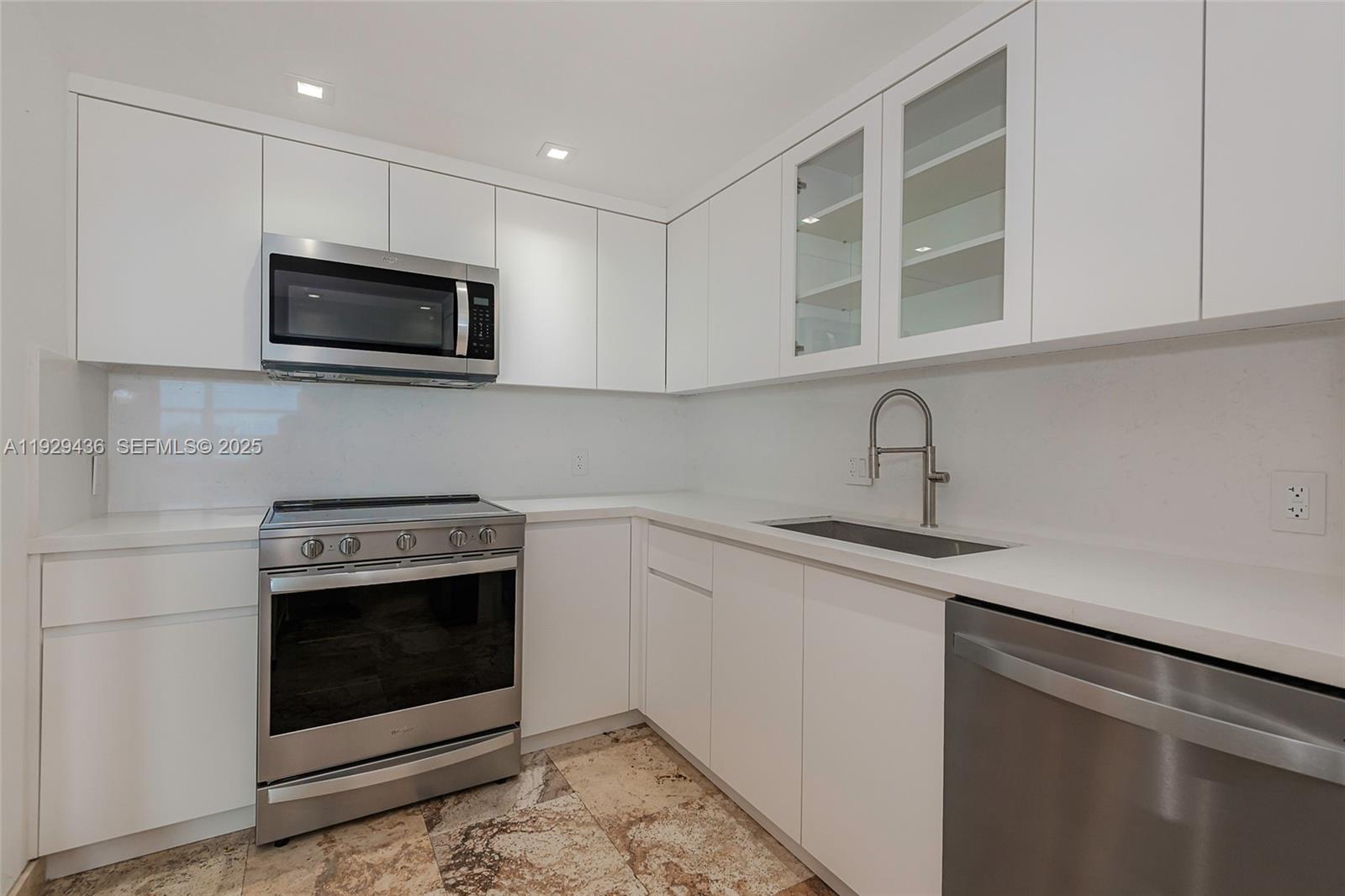 150 Southeast 25th Road, Unit 7J Miami, FL 33129 - Photo 16 of 29 a kitchen with stainless steel appliances granite countertop a sink stove and microwave