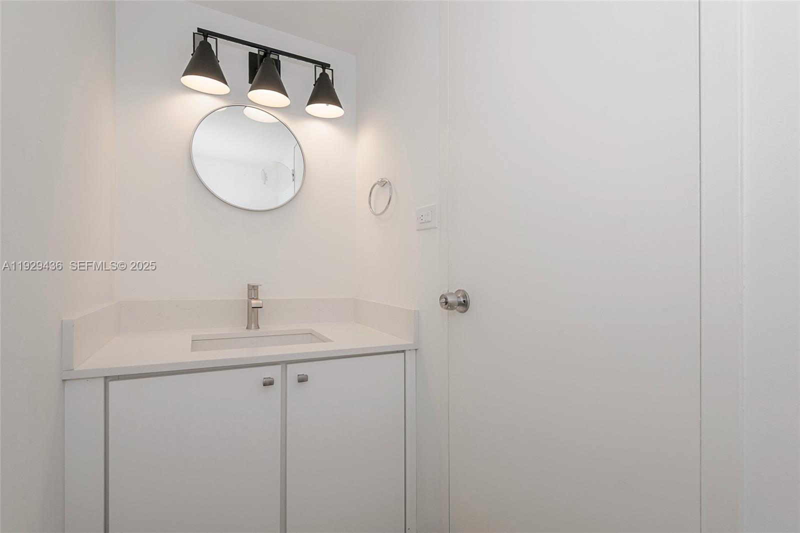 150 Southeast 25th Road, Unit 7J Miami, FL 33129 - Photo 18 of 29 a bathroom with a sink and a mirror