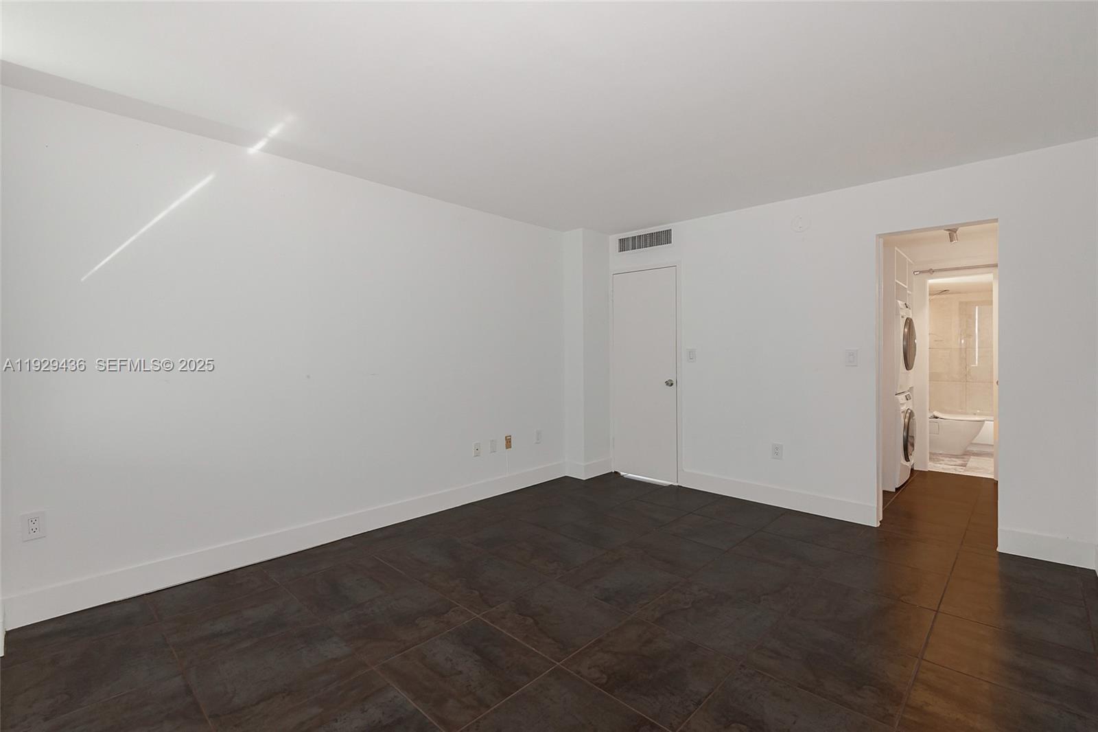 150 Southeast 25th Road, Unit 7J Miami, FL 33129 - Photo 22 of 29 an empty room with wooden floor and windows
