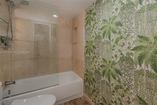 a bathroom with a toilet and shower