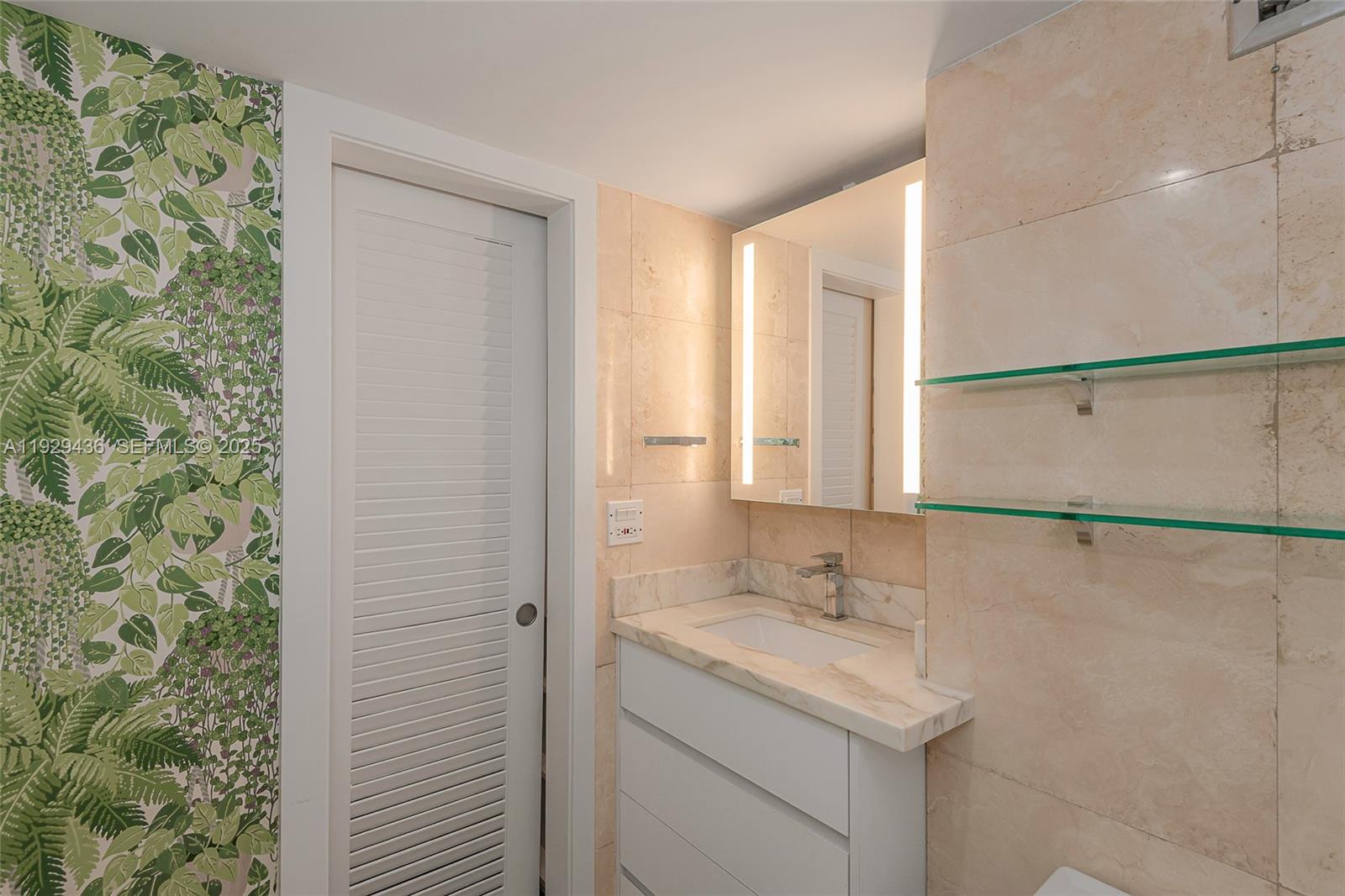 150 Southeast 25th Road, Unit 7J Miami, FL 33129 - Photo 26 of 29 a bathroom with a granite countertop sink a mirror and a shower