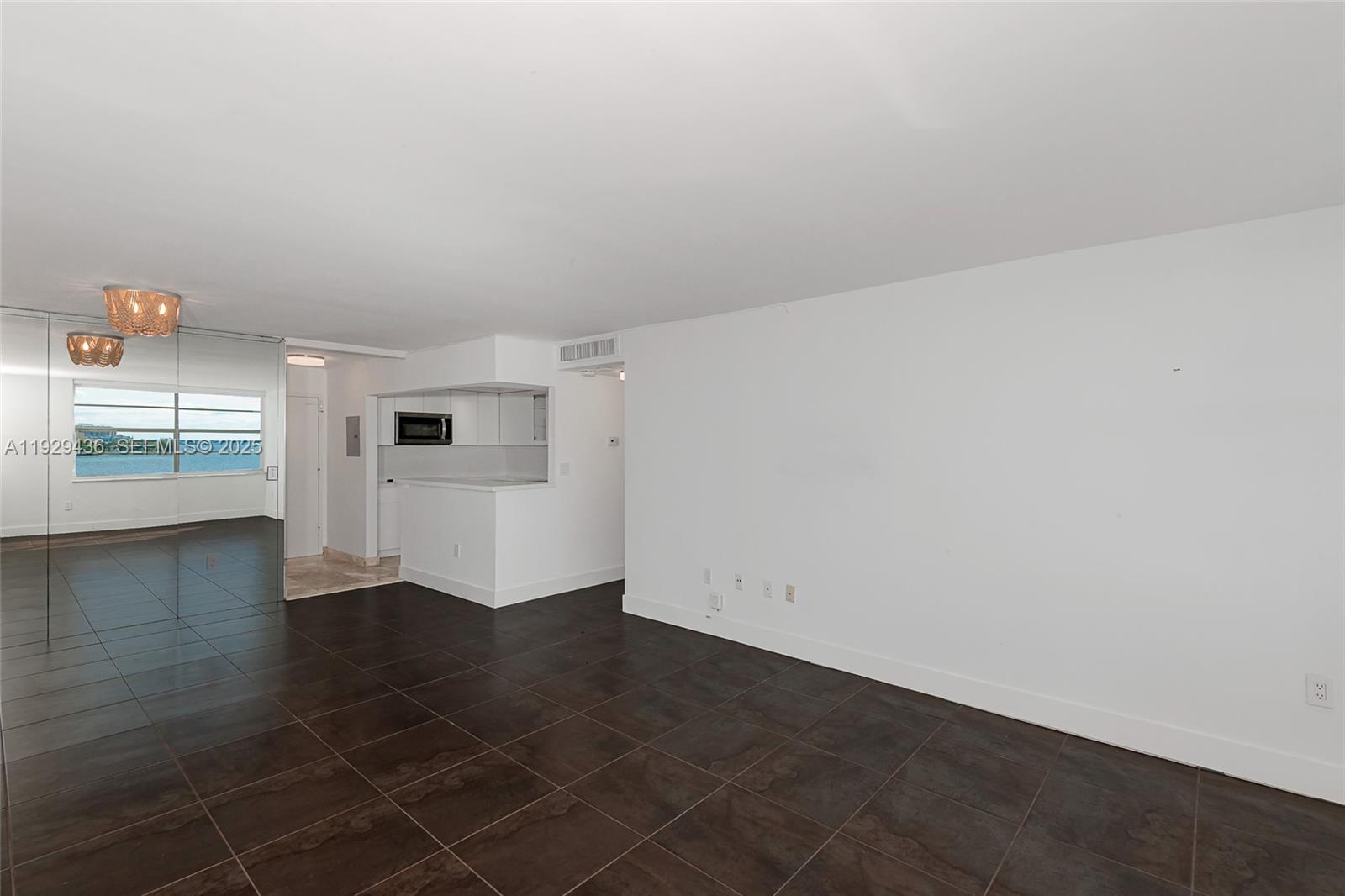 150 Southeast 25th Road, Unit 7J Miami, FL 33129 - Photo 8 of 29 an empty room with wooden floor and windows