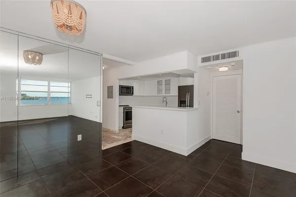 a view of a hallway with a kitchen