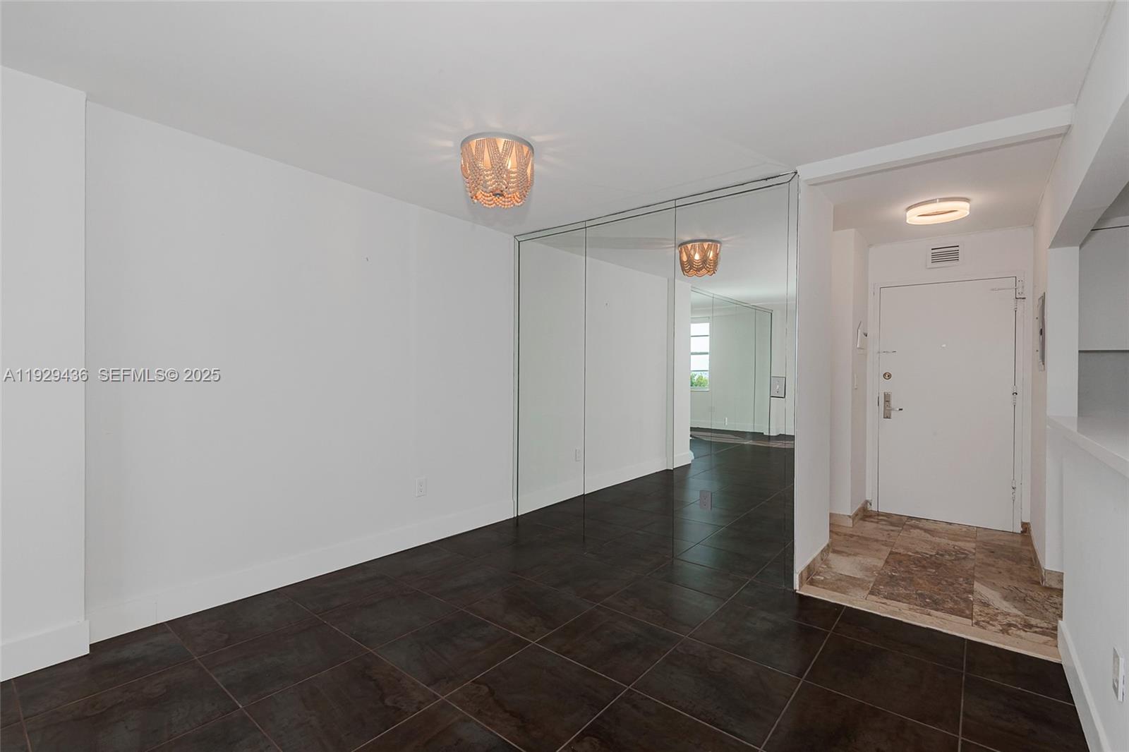150 Southeast 25th Road, Unit 7J Miami, FL 33129 - Photo 10 of 29 an empty room with wooden floor and windows
