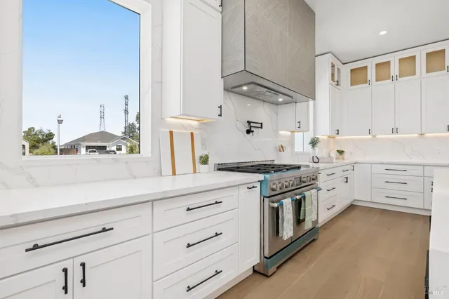 a kitchen with a sink and a stove with living room