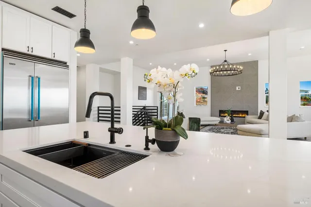 a living room with furniture and a chandelier