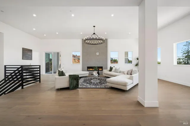 a living room with furniture and chandelier