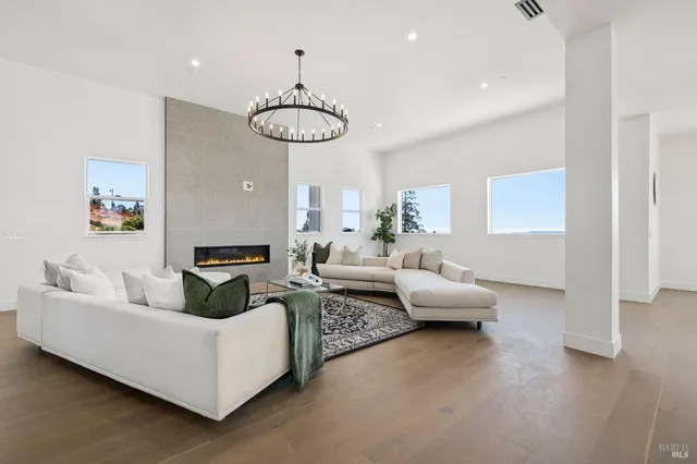 a living room with furniture and a dining table