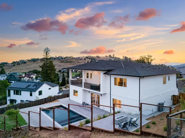 a view of a terrace with furniture and a garden