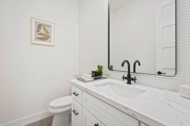 a bathroom with a tub a sink and glass door