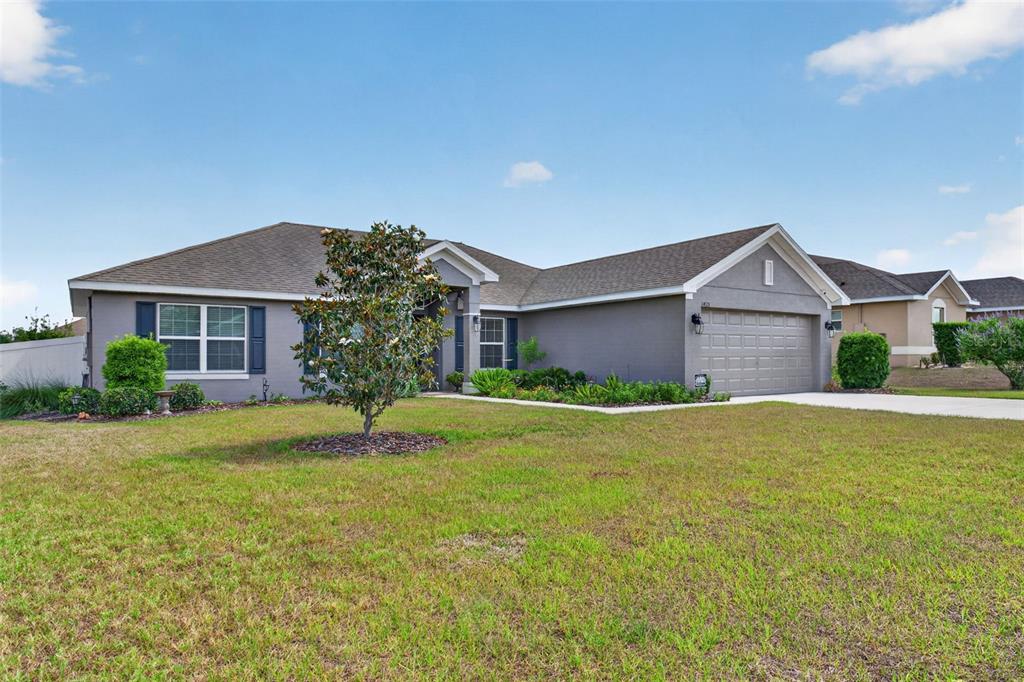 2429 Twin Lake View Road Winter Haven, FL 33881 - Photo 2 of 37 a front view of a house with a yard and garage