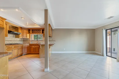a kitchen with stainless steel appliances granite countertop a stove and a refrigerator