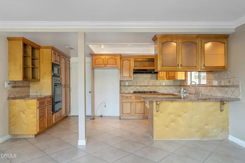 a kitchen with stainless steel appliances granite countertop a sink and cabinets
