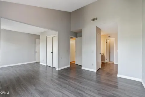 a view of a livingroom with wooden floor and a flat screen tv