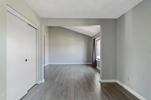 a view of an empty room with glass door and a window