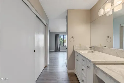 a bathroom with a double vanity sink and a mirror