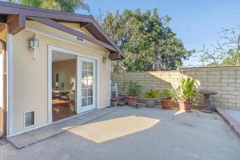 a living room with furniture a rug and a book shelf