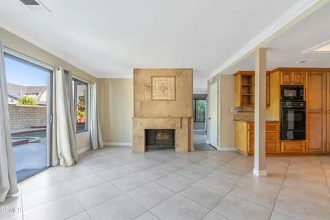 a kitchen with granite countertop a refrigerator and a stove top oven