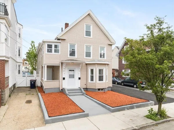 a front view of a house with a yard