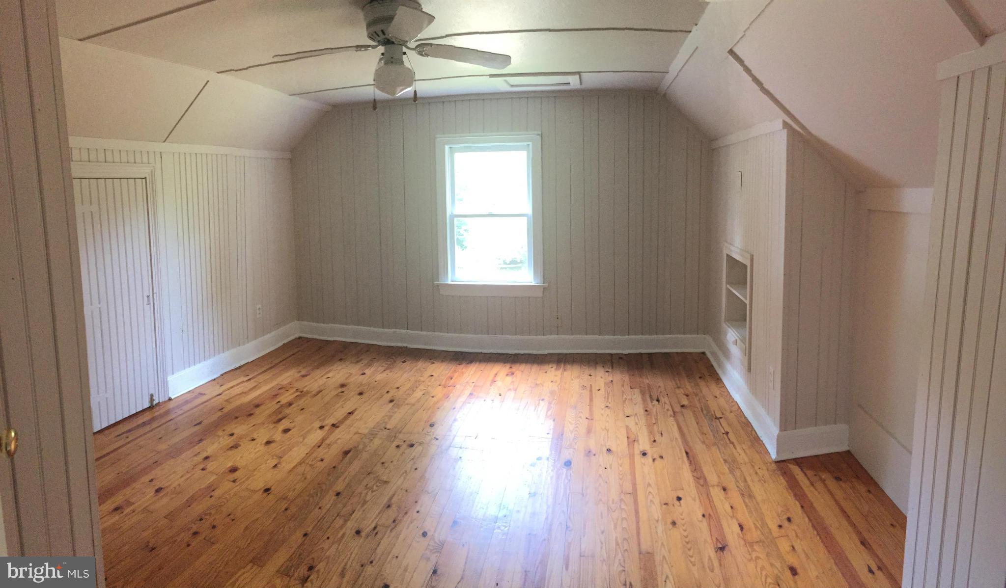9395 Legion Road Denton, MD 21629 - Photo 10 of 21 an empty room with wooden floor and windows