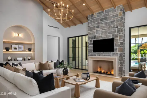 a living room with furniture fireplace and flat screen tv