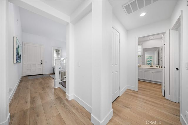 a view of a room with wooden floor and a bathroom