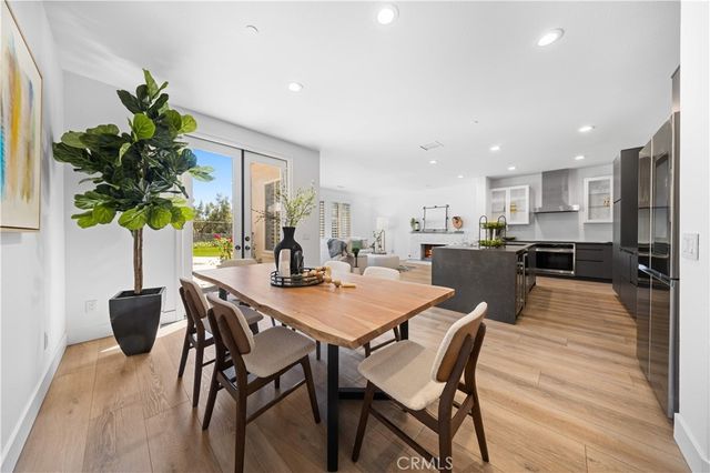 a view of a dining room with furniture and a potted plant
