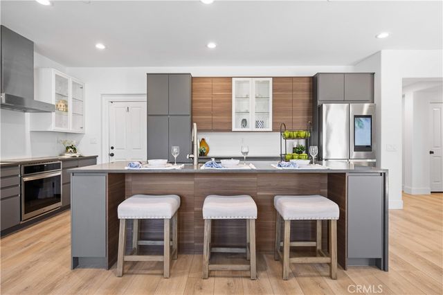 a kitchen with granite countertop a sink and white appliances