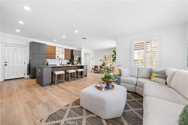 a living room with furniture and kitchen view