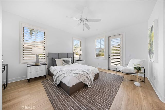a spacious bedroom with a bed and wooden floor