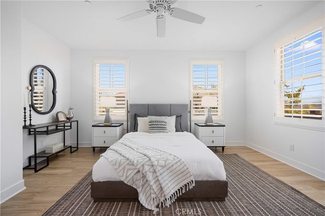 a bedroom with a bed a dresser and chair