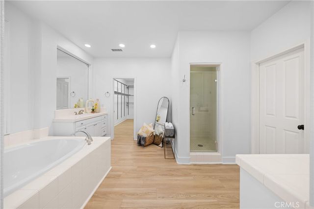 a bathroom with a tub sink and a mirror
