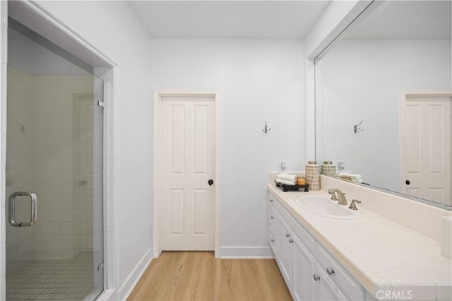 a spacious bathroom with a double vanity sink and mirror