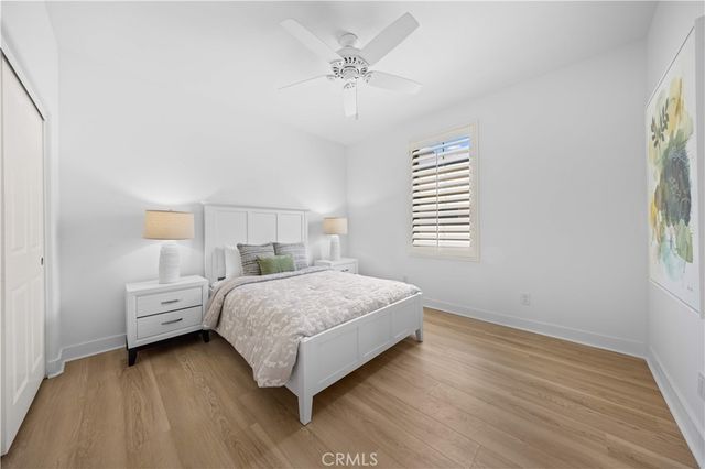 a bedroom with a bed and a painting on the wall