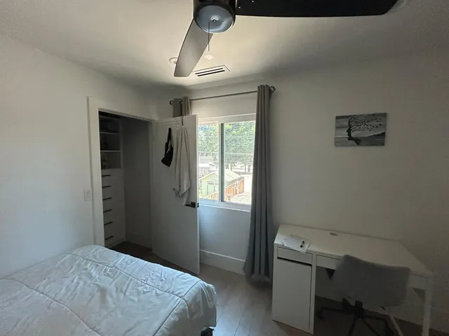 a bedroom with a bed and a window