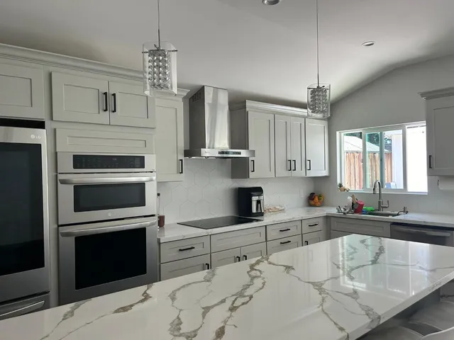 a kitchen with stainless steel appliances a stove sink and microwave
