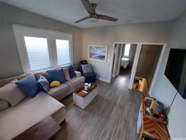 a living room with furniture and wooden floor