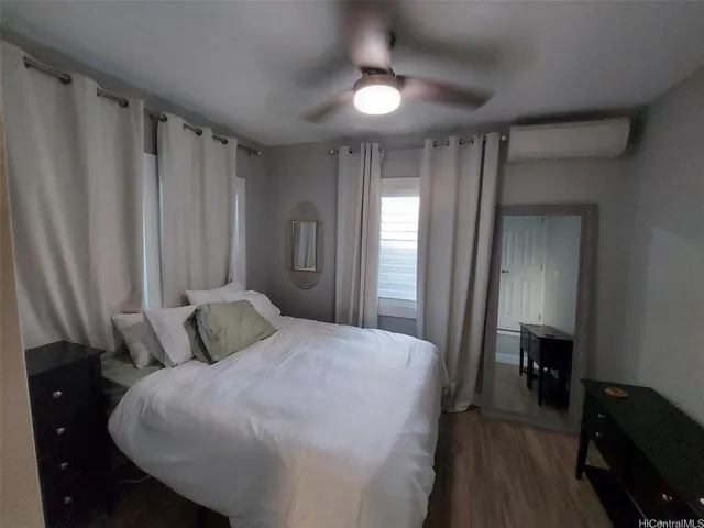 a bedroom with a bed and a mirror