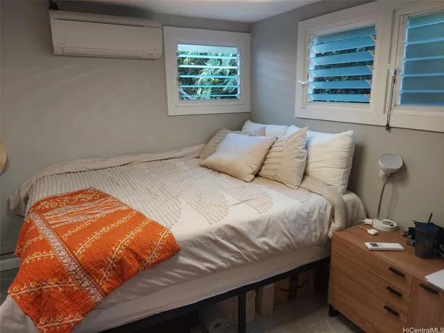 a bedroom with a bed and window