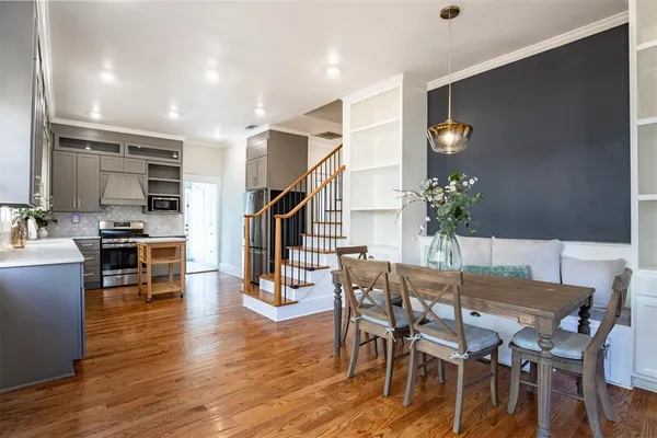a view of a dining room with furniture and wooden floor