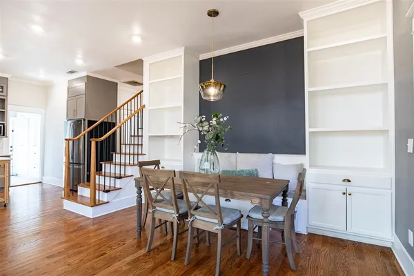 a view of a dining room with furniture and wooden floor