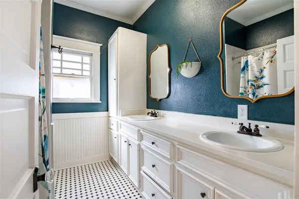 a bathroom with a double vanity sink and a mirror