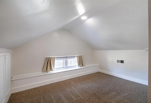 a view of a big room with closet and windows